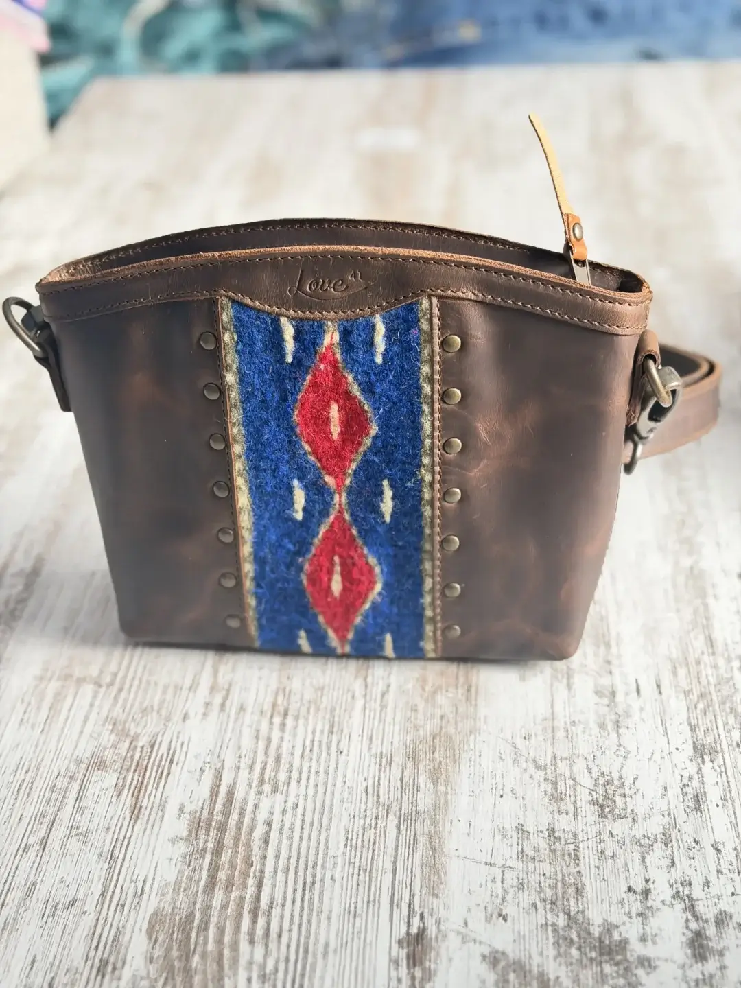 Brown leather bag with colorful design from saddleback leather co. 